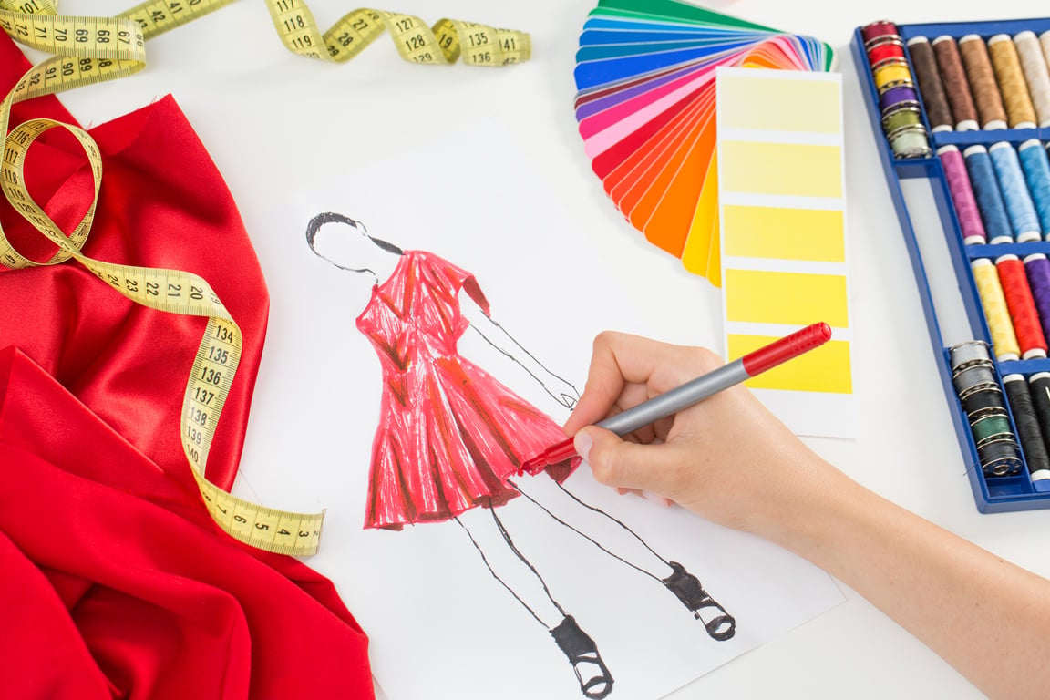 Fashion Designer Sketching A Dress